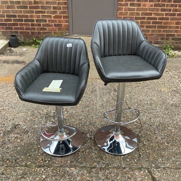 Pair of black John Lewis Swifez bar stools with chrome bases.