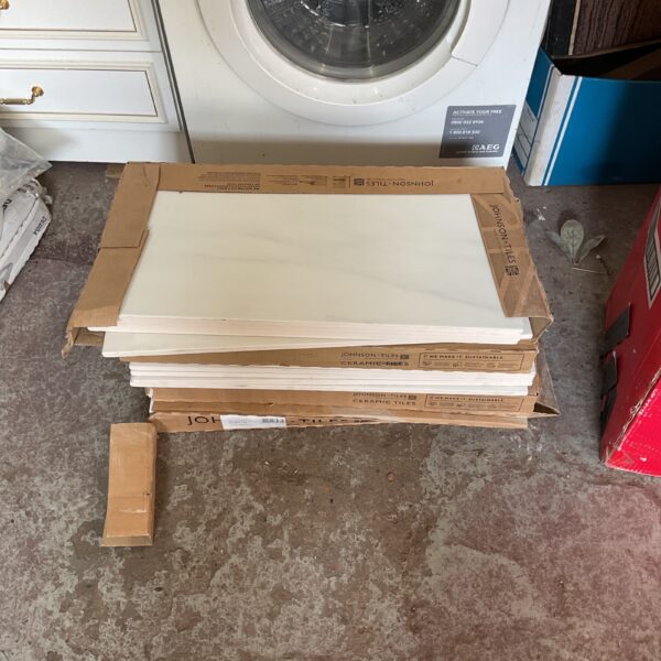 Stack of five boxes of Johnson tiles for renovation projects.