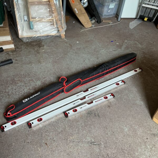 Kapro spirit level set with a red carry case, showing multiple levels.