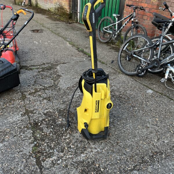 Used Karcher power washer in a garden setting.