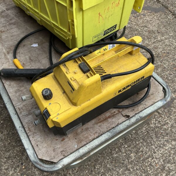 Yellow Karcher powerwasher for garden and patio cleaning.