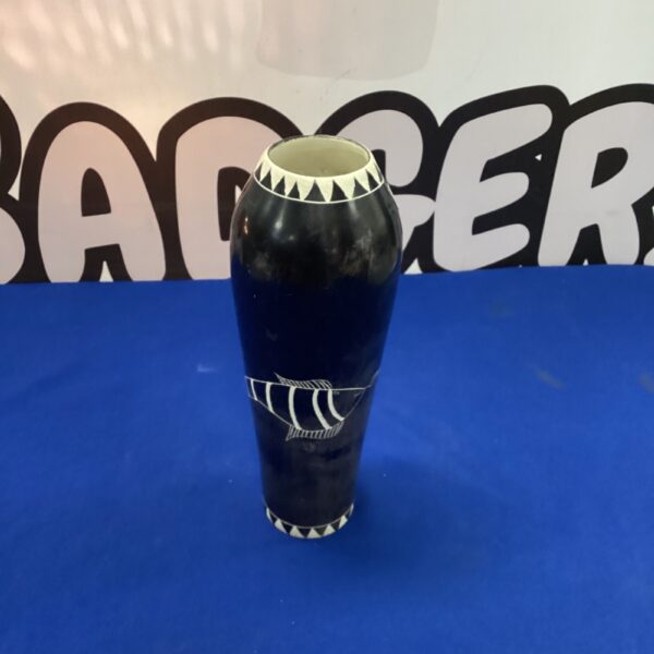 Dark Kenyan stone vase with geometric pattern.