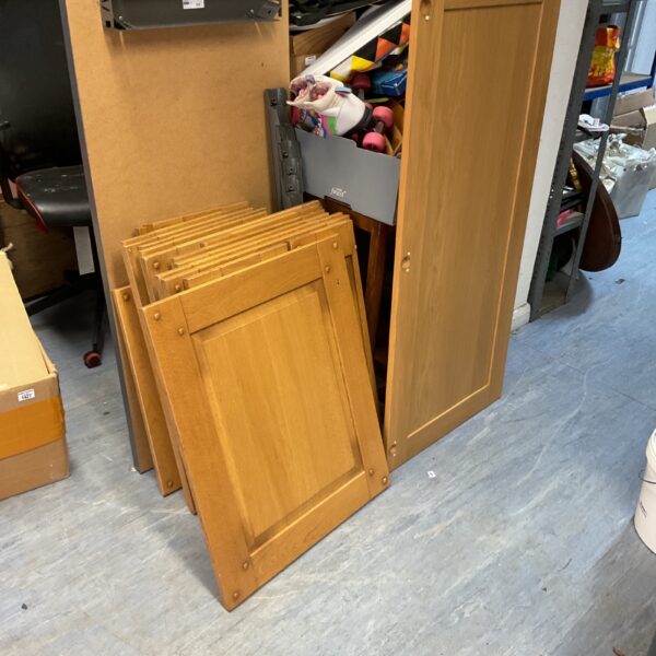 Large lot of wooden kitchen cabinet doors with fittings for renovation.
