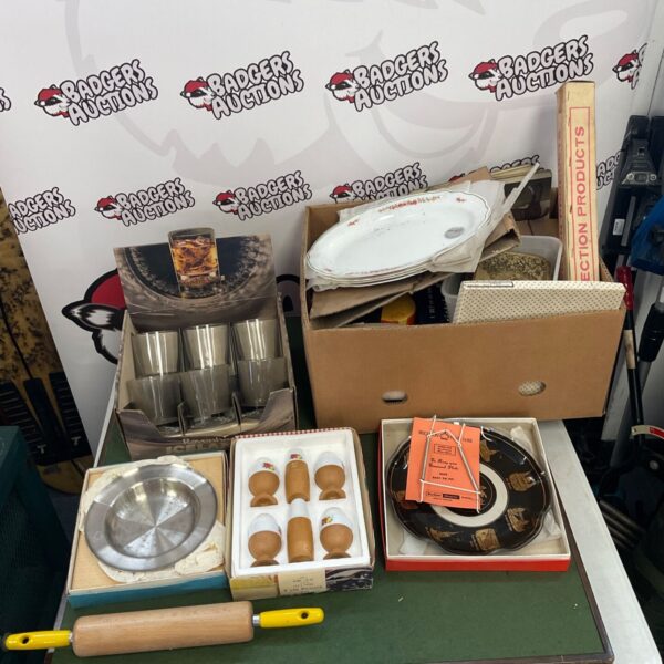 Kitchen clearance lot with plates, egg cups, and rolling pin.