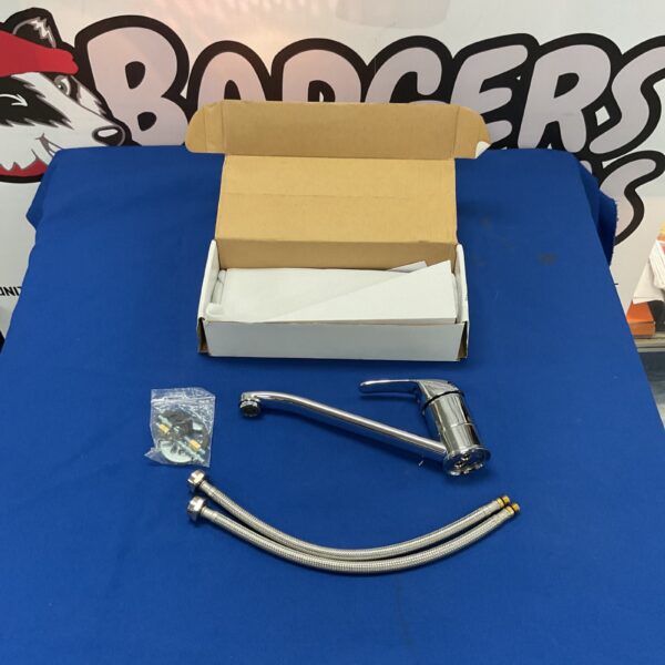 Chrome kitchen sink mixer tap with flexible hoses.
