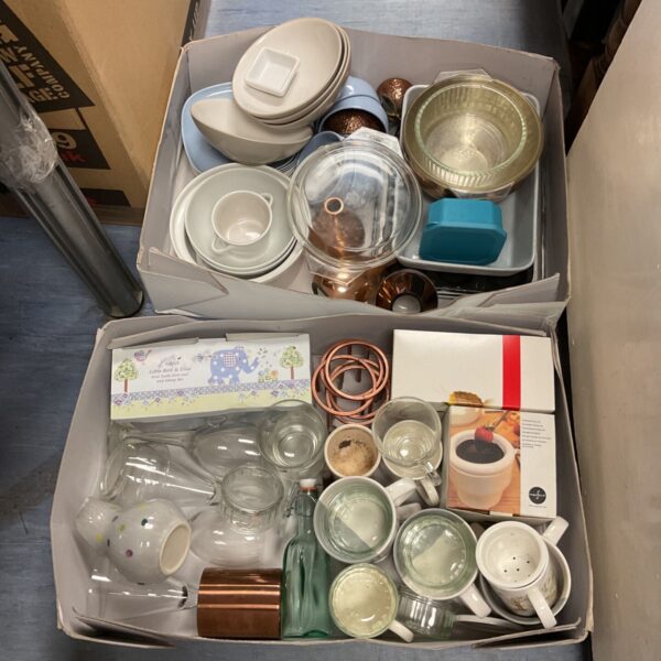 Assorted kitchenware lot including plates, bowls, and a fondue set.