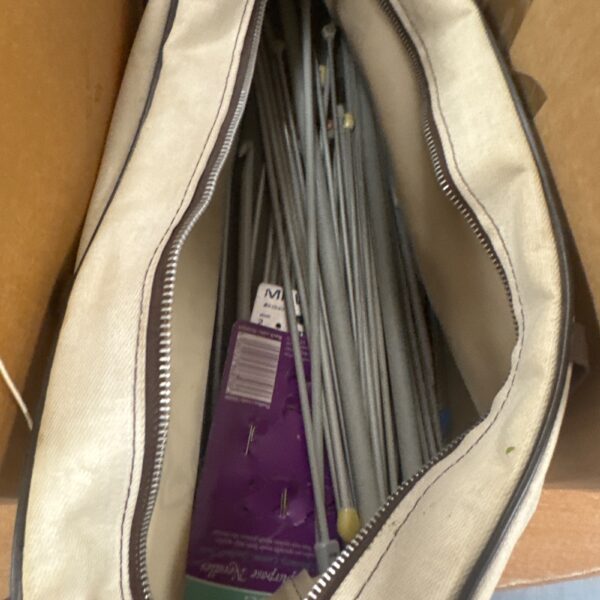 Assorted knitting needles in a bag, vintage craft supplies.