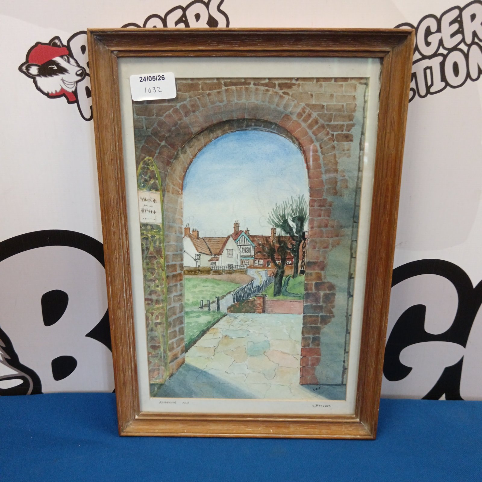L Tilley watercolour painting of a quaint riverside cottage.