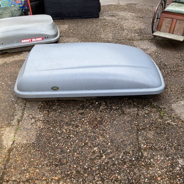 Dark grey Land Rover roof box for car storage.