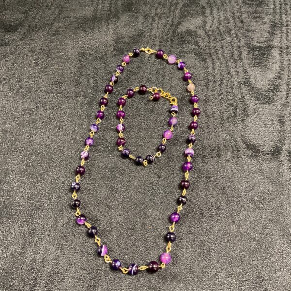 Vibrant lapis lazuli necklace and bracelet set with gold accents.