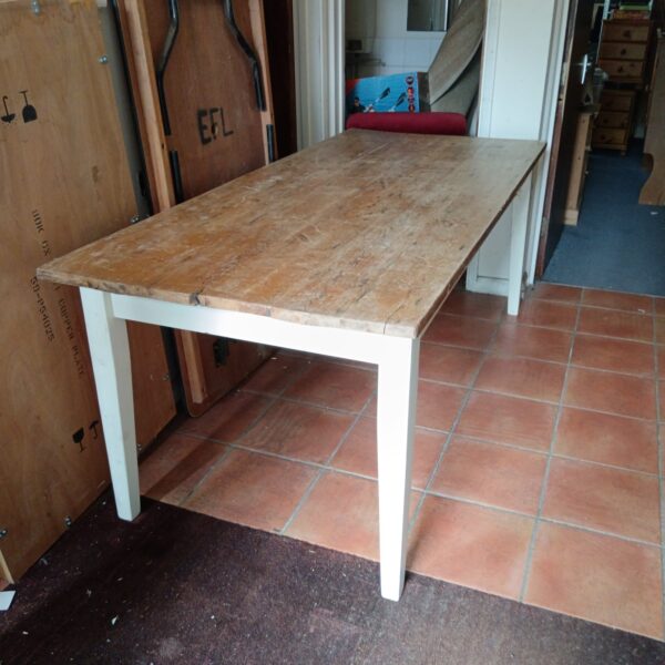 Large pine kitchen table with rustic finish, ideal for farmhouse kitchens.