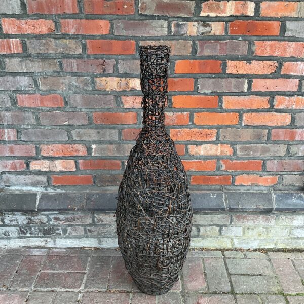 Large dark brown rattan vase for dried flowers.