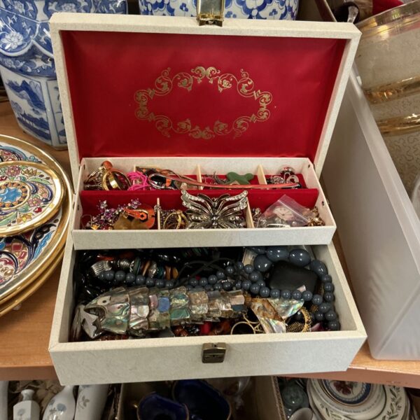 Vintage leather jewellery box filled with assorted jewellery and accessories.
