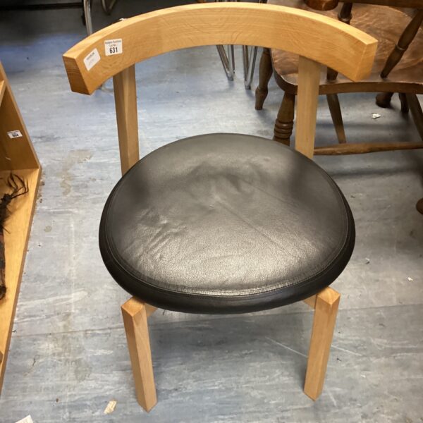 Vintage leather reception chair with wooden frame.