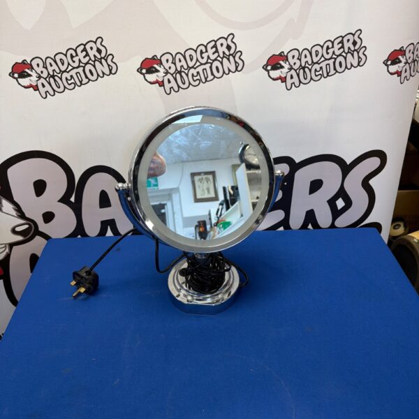 Close-up of large LED vanity mirror with bright illumination.