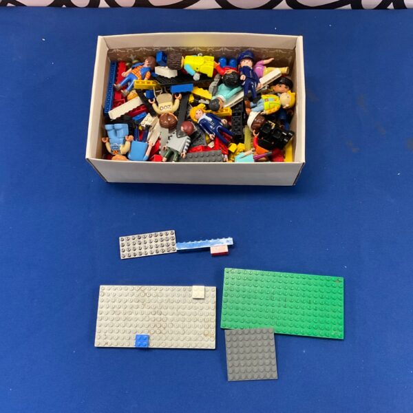 Mixed Lego and Playmobil lot with colourful bricks and figures.