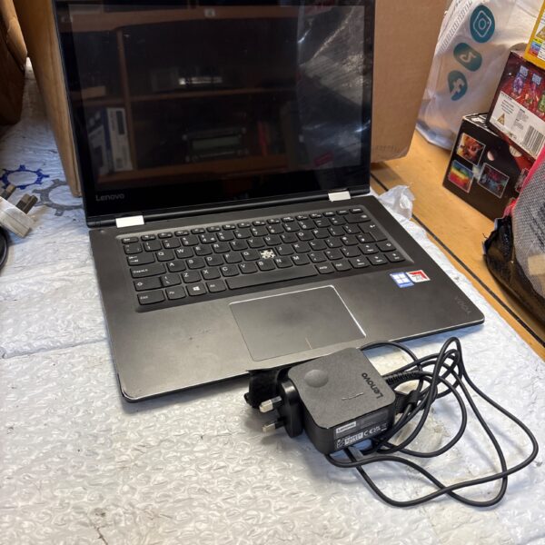 Black Lenovo Yoga laptop with charger included.