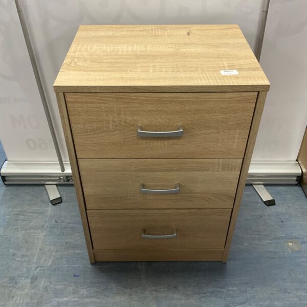 Light oak bedside drawers with three drawers for bedroom storage.