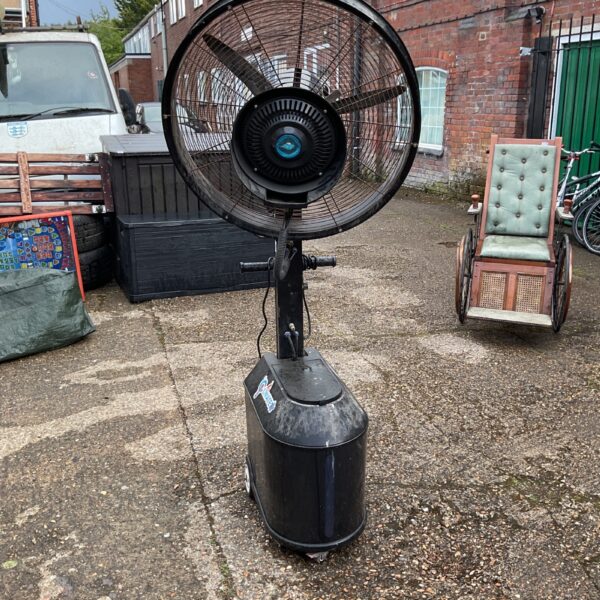 Side view of a used Limate mist fan with a wheeled base.