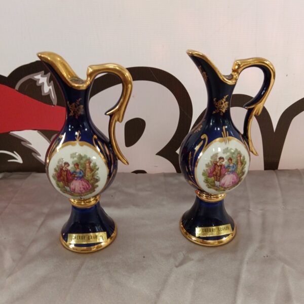 Pair of vintage Limoges cherry brandy bottles with hand-painted details.