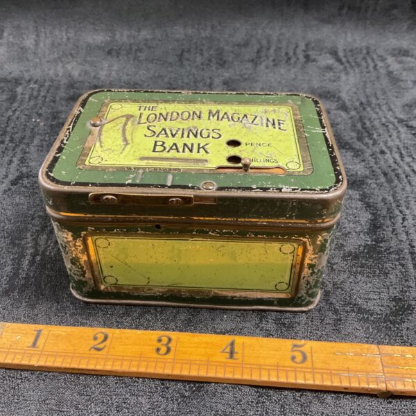Vintage London Magazine Savings Bank tin with pence and shillings slots.