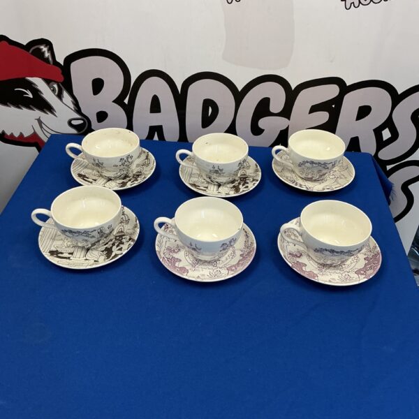 Antique Louis Rosen Schmidt cups and saucers with floral patterns.