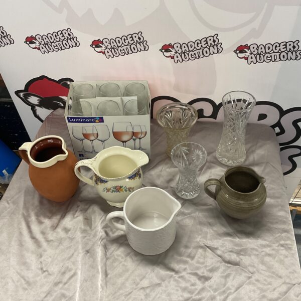 Vintage Luminarc wine glasses and decorative jugs on display.
