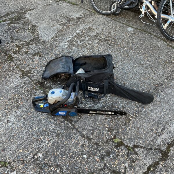 Used Mac Allister petrol chainsaw in a black carrying case.