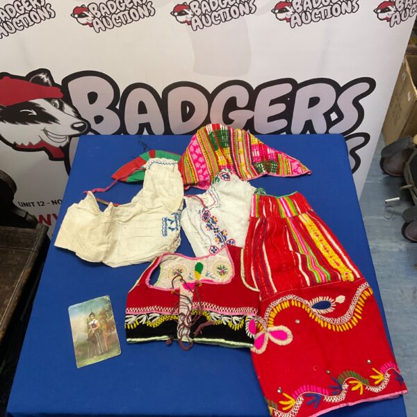 Vibrant Madeira costume set with embroidered blouse and red skirt.
