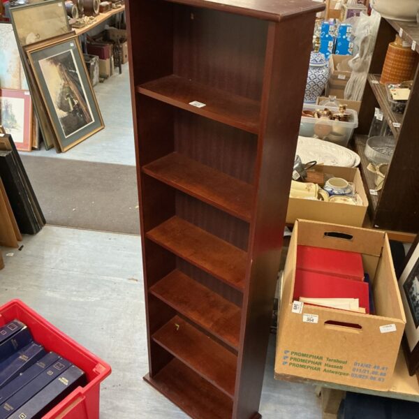 Antique mahogany bookcase with three shelves, ideal for a home library.