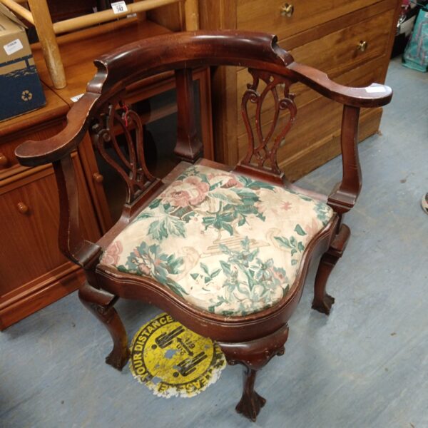 Reproduction mahogany corner chair with floral upholstery.