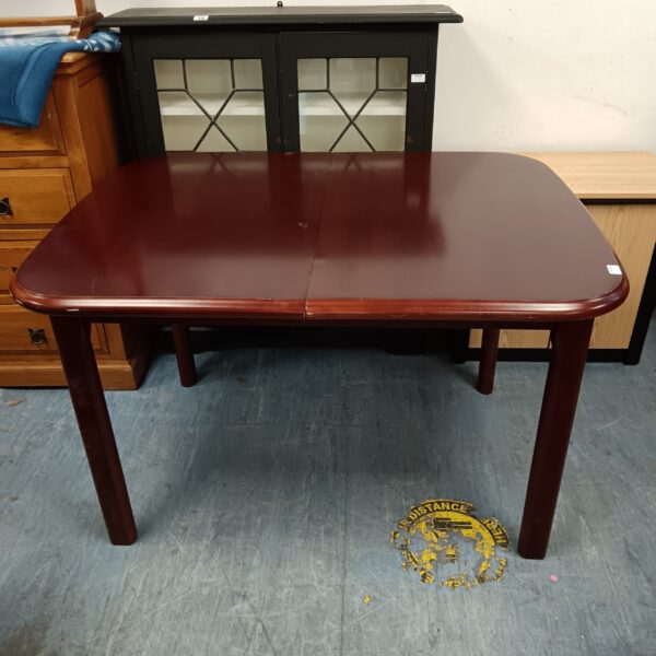 Rich mahogany extending dining table, vintage wood furniture.