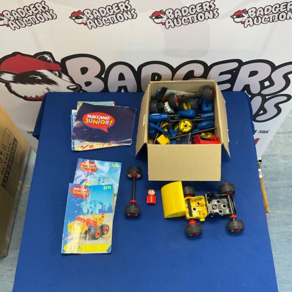 Meccano Junior parts lot with boxes and construction pieces.