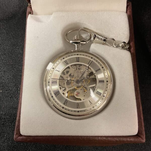 Detailed mechanical pocket watch with skeleton movement and chain.