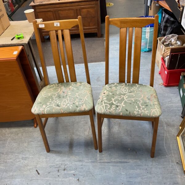 Vintage mid-century modern dining chair with floral upholstery.
