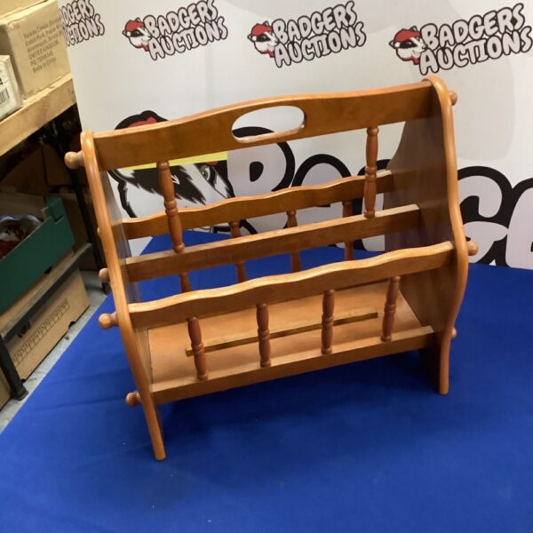Vintage mid-century wooden magazine rack for storing periodicals.