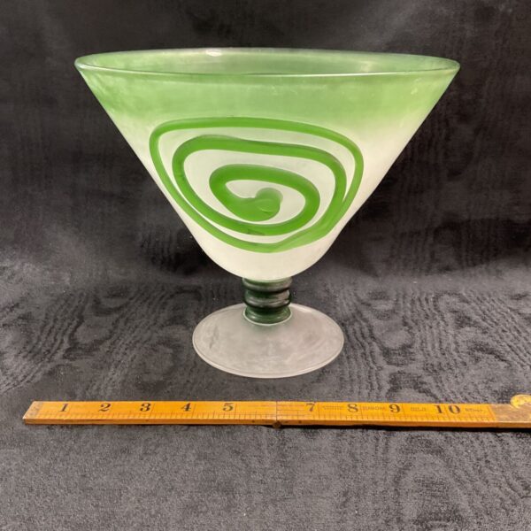 Vintage mid-century modern swirl glass bowl on a ruler.