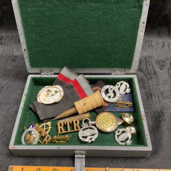 Open military badge box with Royal Tank Regiment insignia.