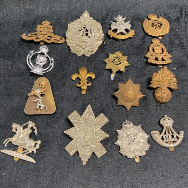 Collection of vintage British Army military cap badges.