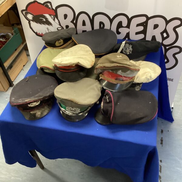 Collection of vintage military caps including American and Russian styles.