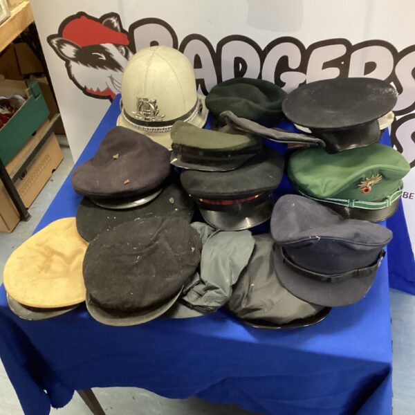 Mixed lot of vintage military hats including Royal Navy and British Army caps.