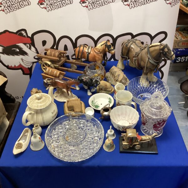 Vintage miniature teapot collection with Wade animal ornaments on display.
