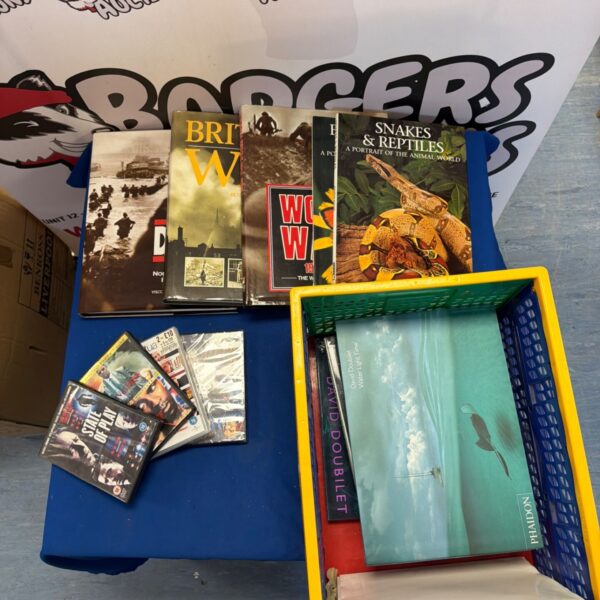 Mixed lot of books and DVDs for sale, including reptile guides.