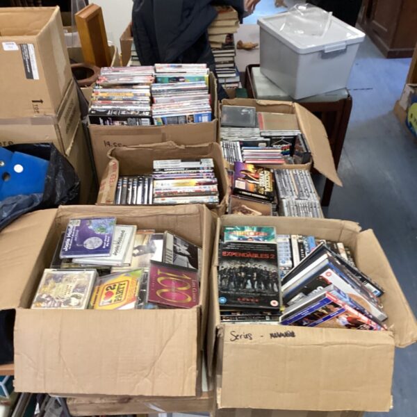 Mixed lot of music CDs and movie DVDs for sale.