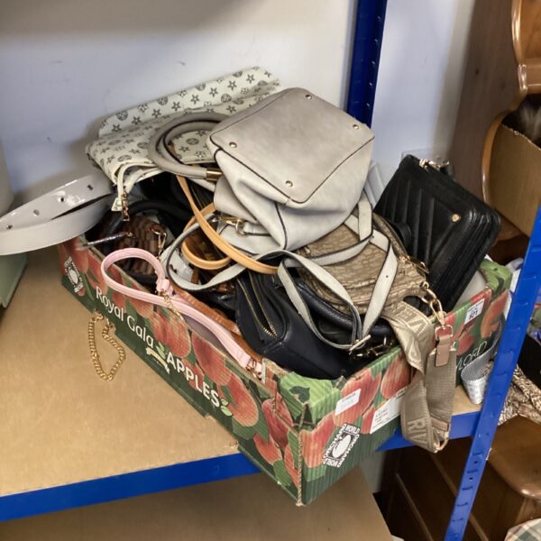 Mixed lot of handbags with varied styles and colours.