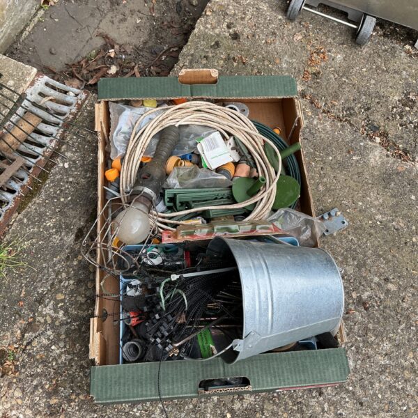 Tray of mixed cables, hardware, and cable ties for DIY projects.