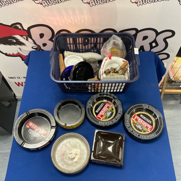 Mixed lot of dog bowls and collectibles in a basket.