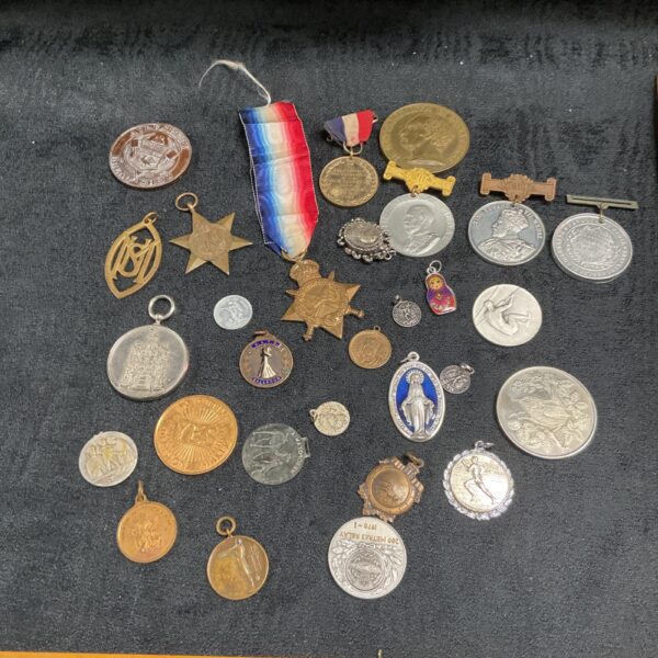 Mixed lot of vintage medals and coins, including a WWI ribbon.