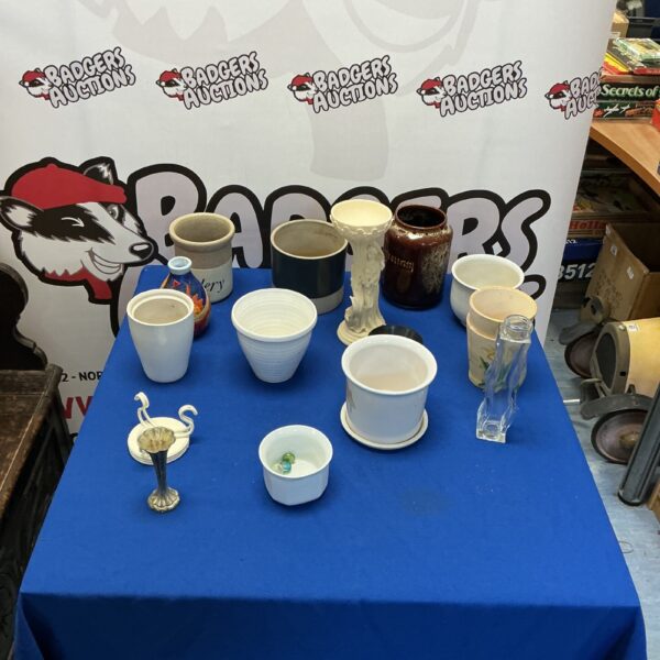 Assorted mixed pottery collection including plant pots and decorative items.