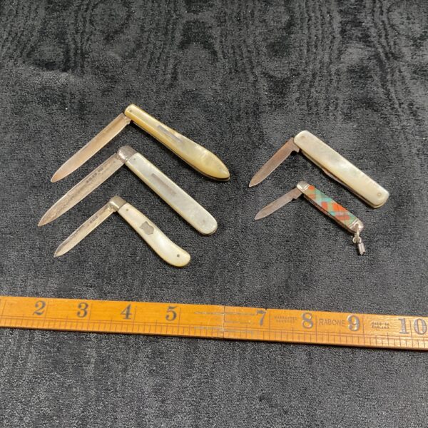Antique lot of mother of pearl fruit knives with silver blades.